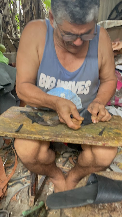 Local artisan working recycled tire rubber